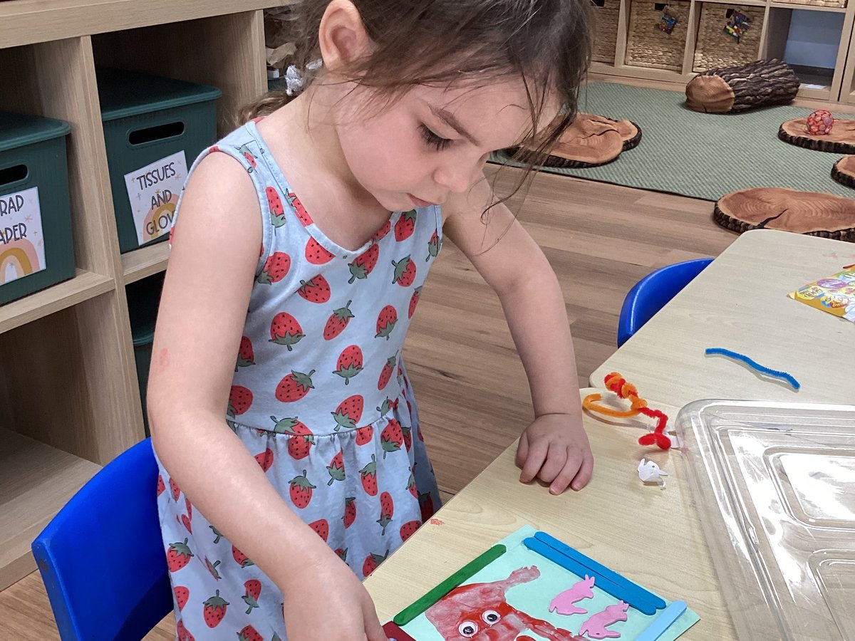 A child concentrating on a craft project &mdash; a learning moment captured for parents